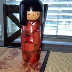 Beautiful kokeshi with kimono and flowers.